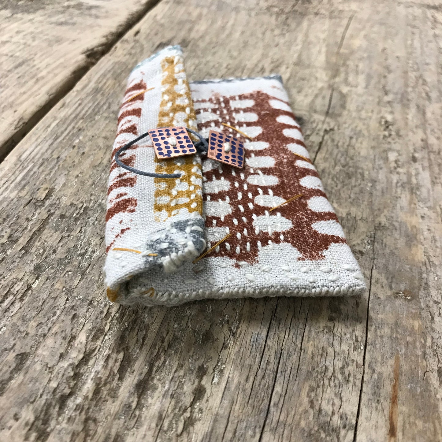 hand stitched keepsake pouch with copper buttons
