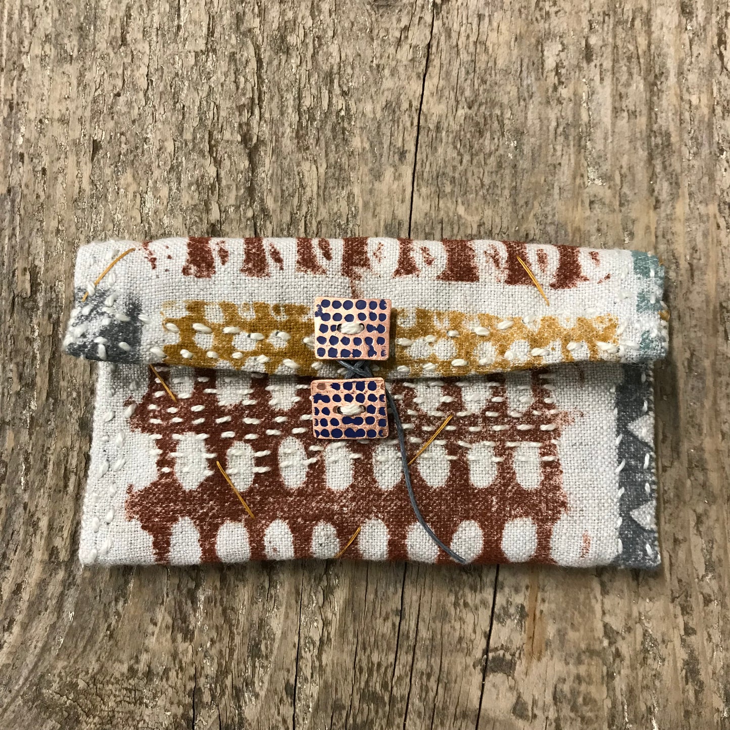 hand stitched keepsake pouch with copper buttons