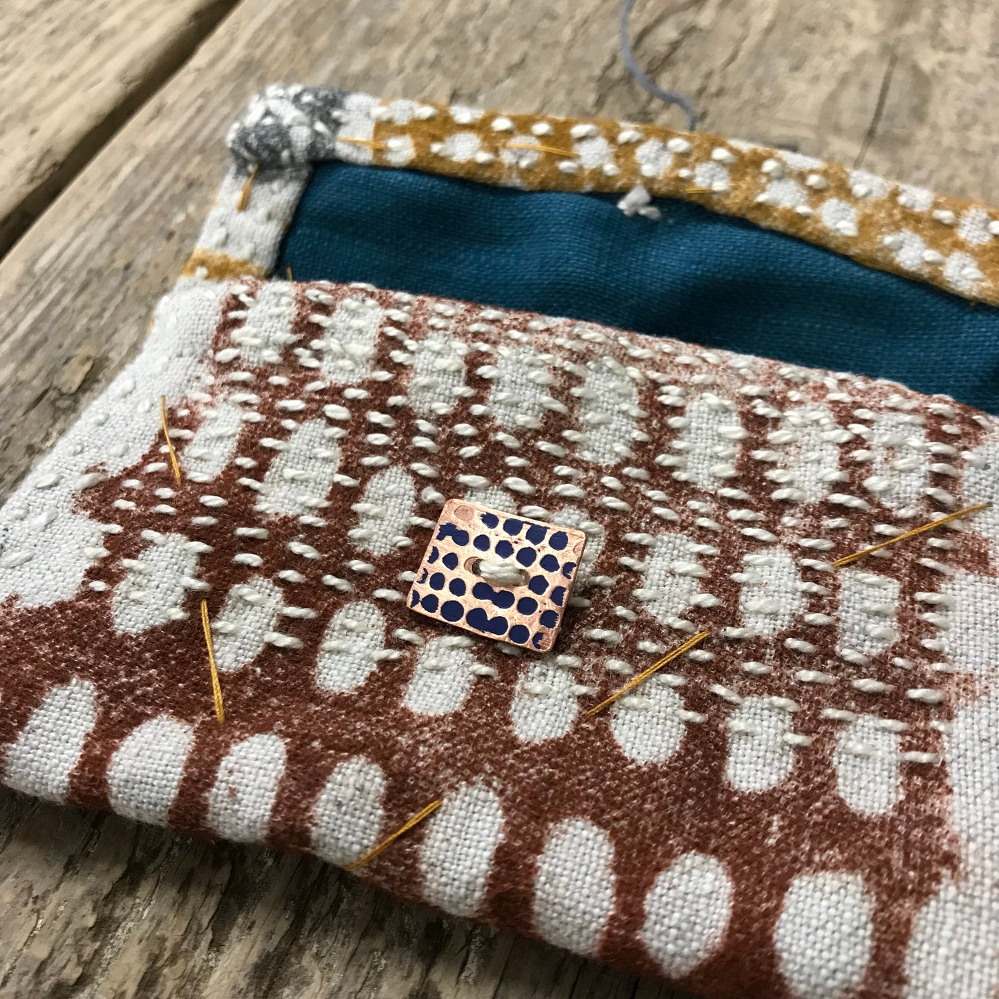hand stitched keepsake pouch with copper buttons