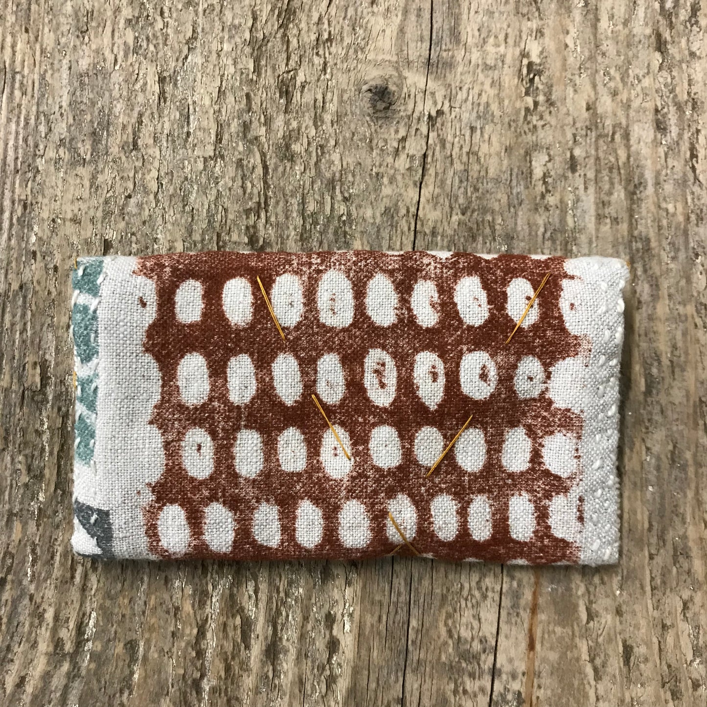 hand stitched keepsake pouch with copper buttons
