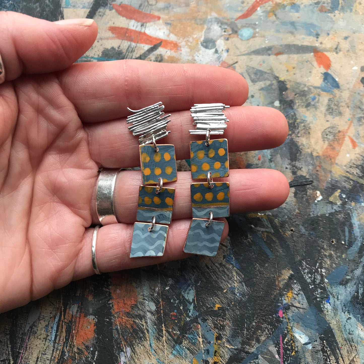 the ON THE CUSP earrings with orange spots & blue waves
