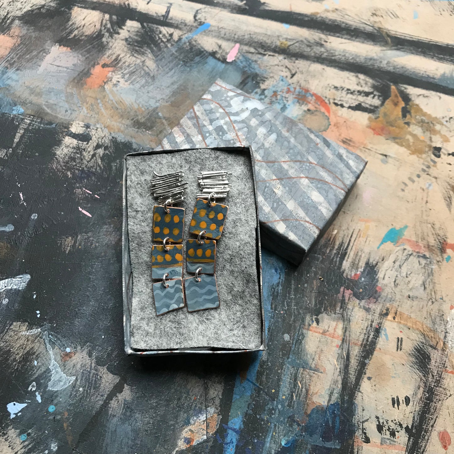 the ON THE CUSP earrings with orange spots & blue waves