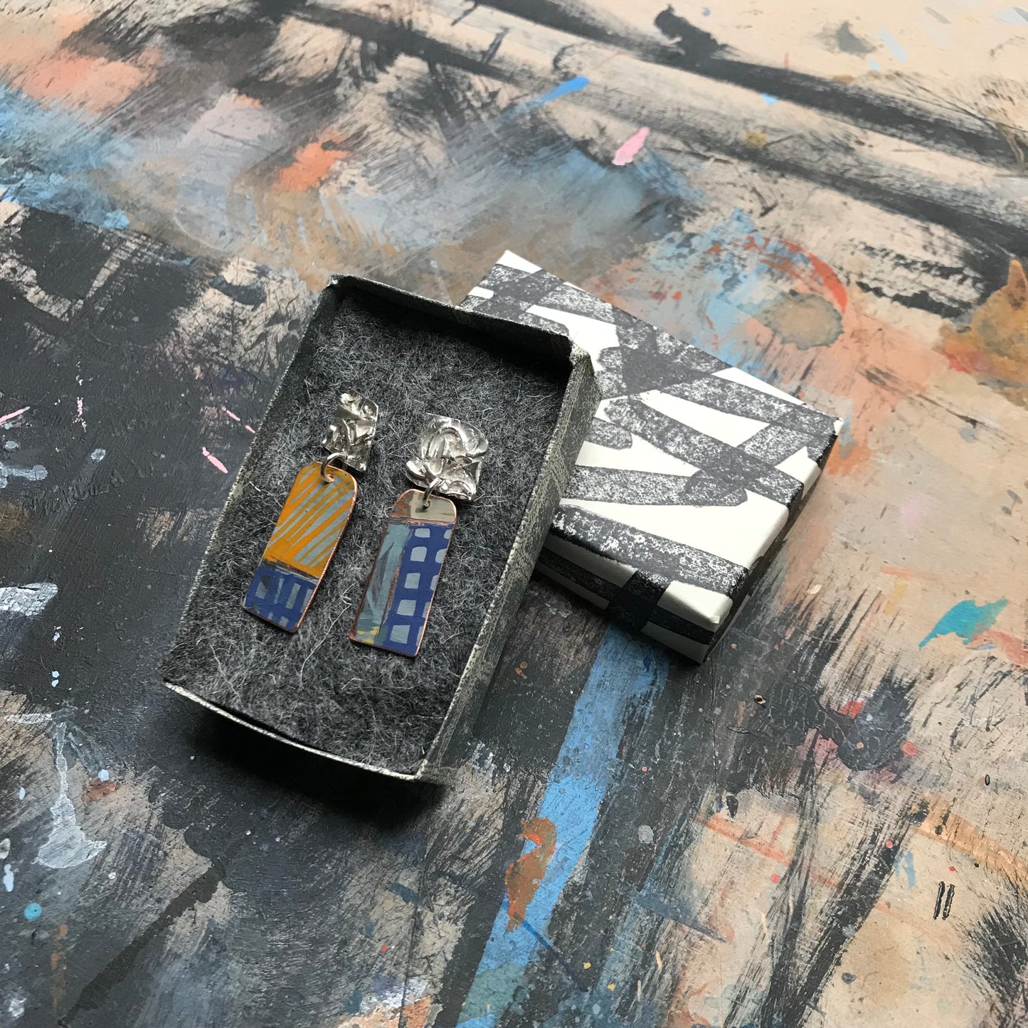 the raw sketch ON THE CUSP earrings with blue grid
