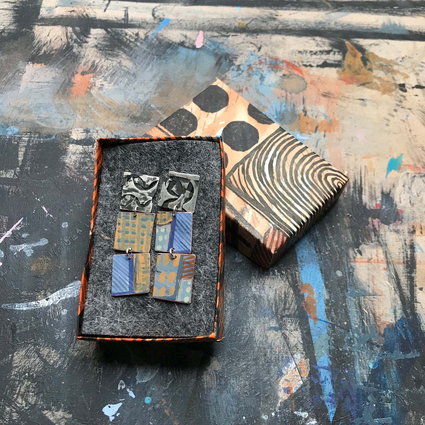 the raw collaged ON THE CUSP earrings with blue stripes