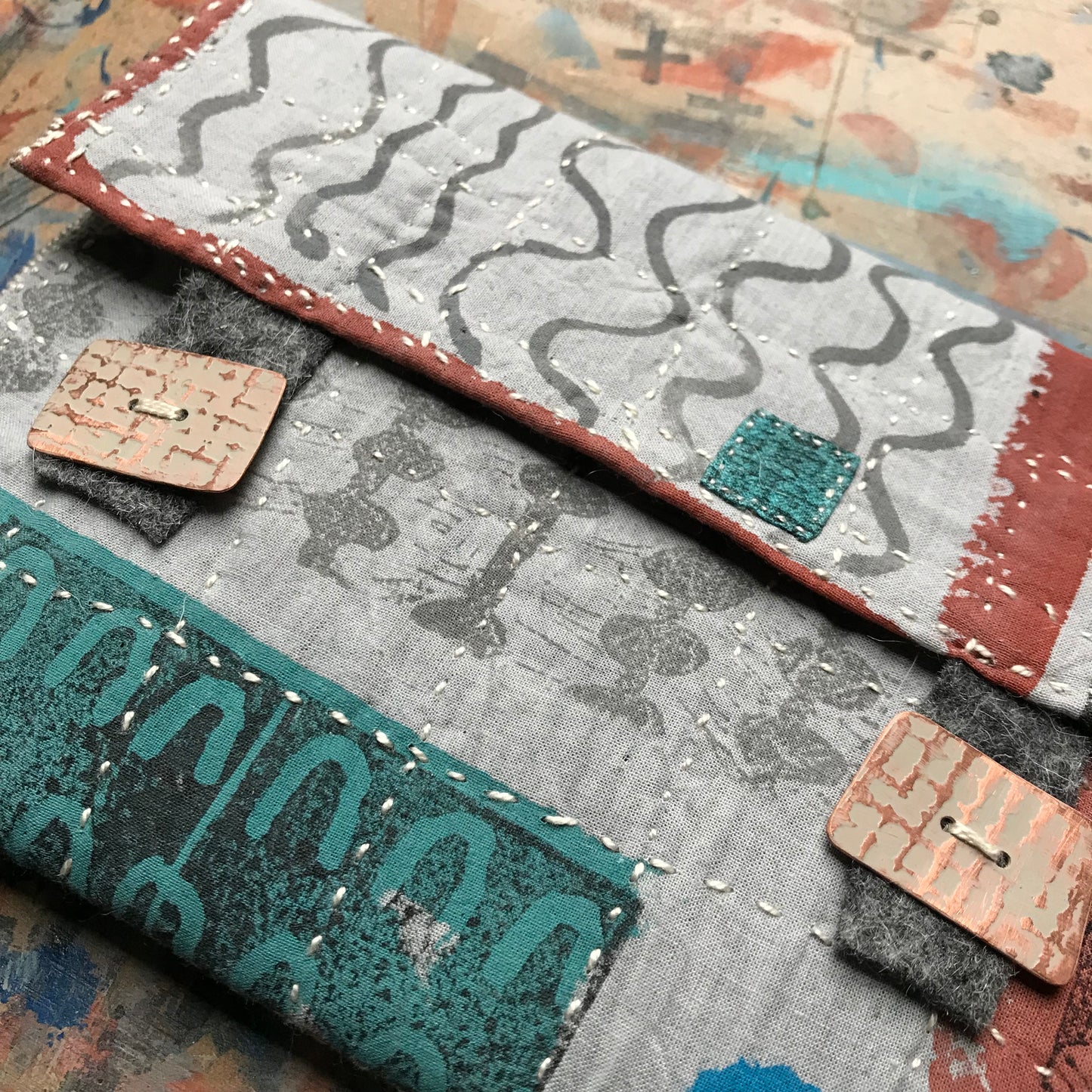 the PALE GREY pouch with textured buttons