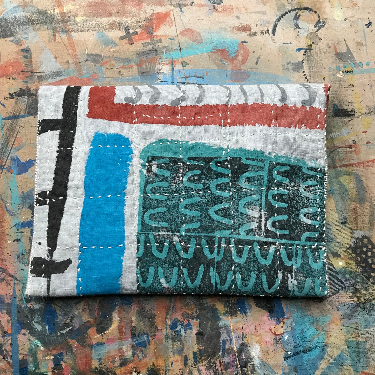 the PALE GREY pouch with textured buttons