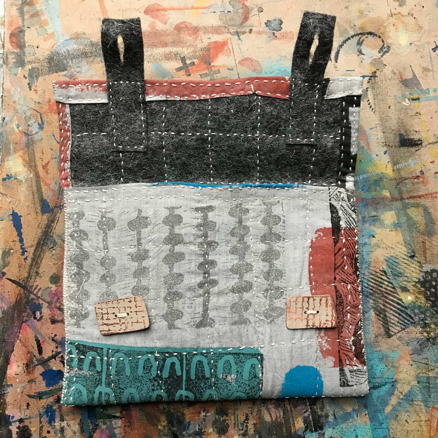 the PALE GREY pouch with textured buttons