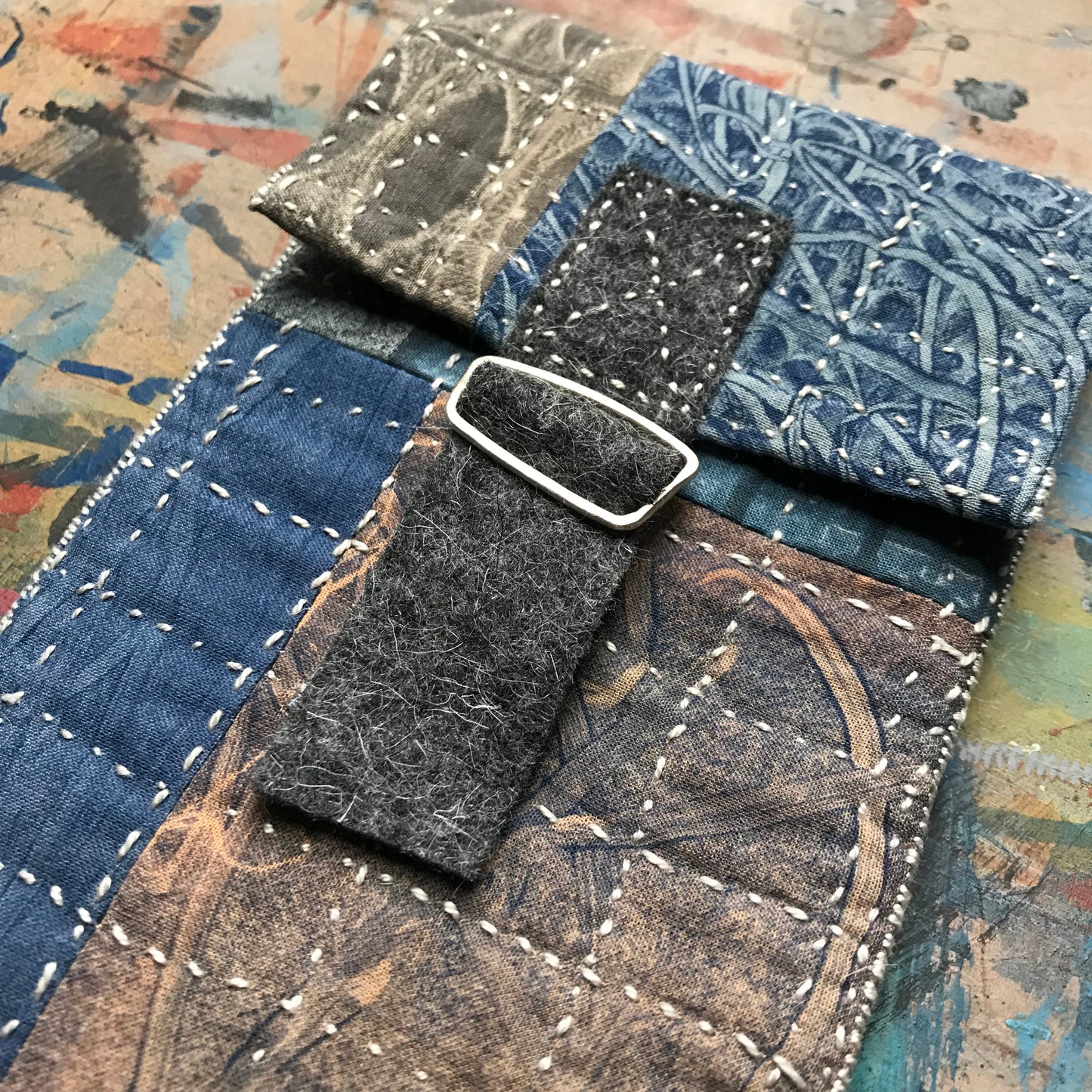 the SLIM PATCHWORK pouch with silver buckle